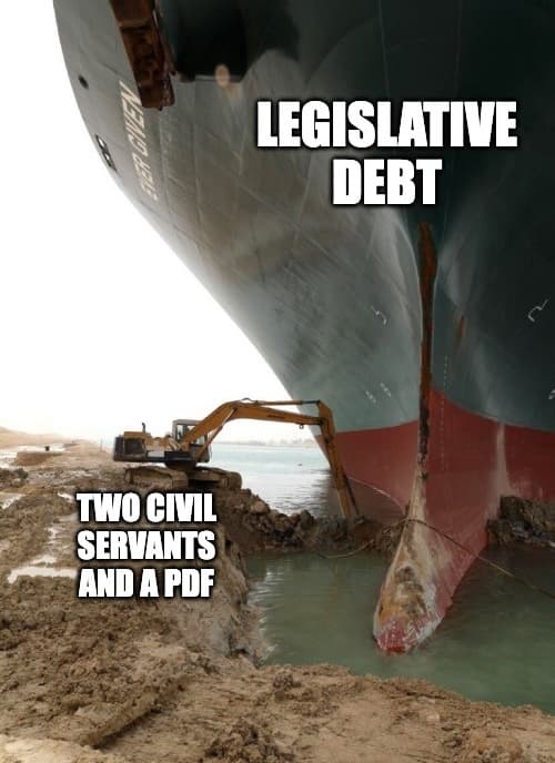 Meme: the vast bow of the Ever Given container ship labelled 'legislative debt' towers over a tiny excavator labelled 'two civil servants and a PDF'